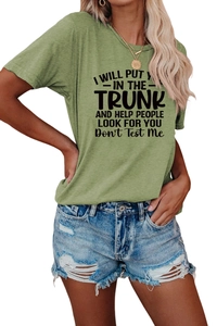Close-up of grass green crew neck tee with bold black quote print and fabric texture