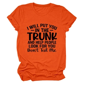 Close-up of bright orange crewneck t-shirt with black graphic slogan text detail
