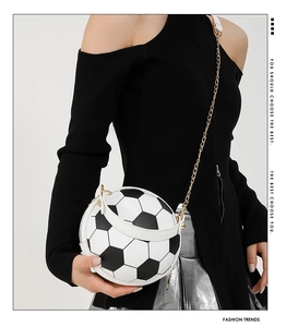 Close-up of a trendy football-shaped chain bag with classic black and white panel details