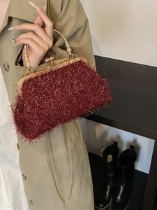 Elegant burgundy evening clutch bag with fringe glitter finish and gold ring handle