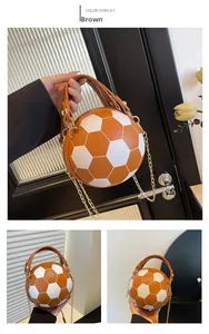 Detail of soccer-shaped crossbody bag featuring orange leather panels and gold chain strap