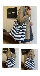 Detail view of large navy blue and white striped canvas tote bag with long straps