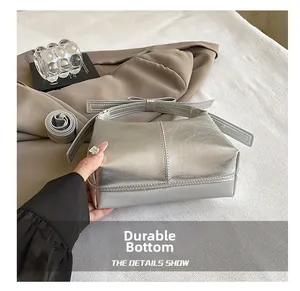 Detail shot of the durable wear-resistant bottom on this silver metallic leather handbag