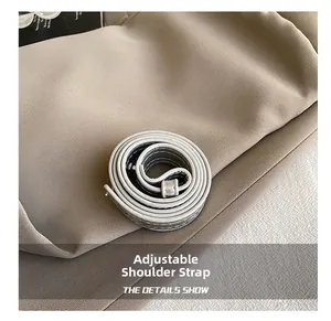 Close-up of adjustable metallic silver shoulder strap with durable metal hardware