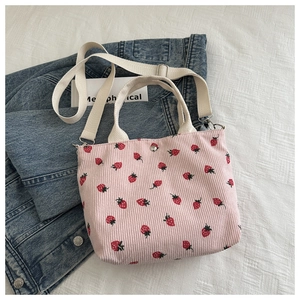 Pink corduroy tote bag with strawberry print and adjustable canvas shoulder strap