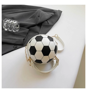 Detail of creative soccer-shaped handbag with black and white leather and gold chain