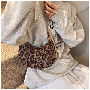 Detail of leopard print crescent moon bag showing soft fabric texture and strap