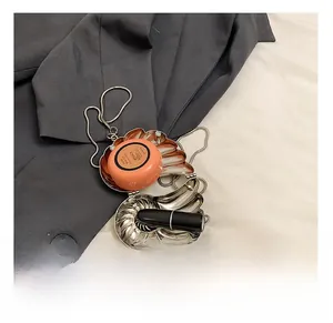 Interior detail of seashell metal evening bag showing capacity for lipstick and cushion