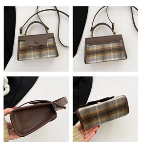 Detail view showing textured plaid fabric, stitching, and interior space of the square bag