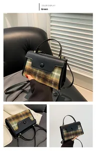Close-up of British style green plaid fabric and smooth black faux leather trim