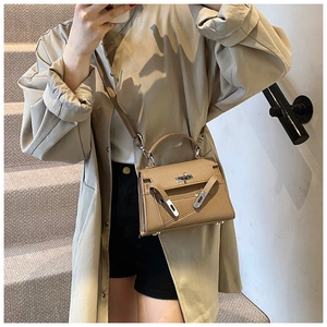 Litchi texture khaki crossbody bag with silver clasp shown on model