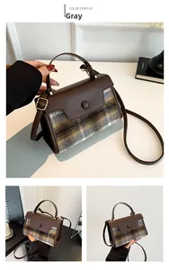 Detail view of grey plaid woolen handbag with contrasting brown faux leather flap