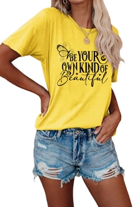 Detail of yellow cotton T-shirt featuring 'BE YOUR OWN KIND OF BEAUTIFUL' slogan and butterfly print