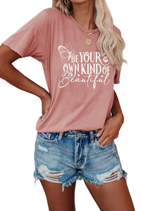Detail of pink T-shirt with BE YOUR OWN KIND OF Beautiful text and butterfly print