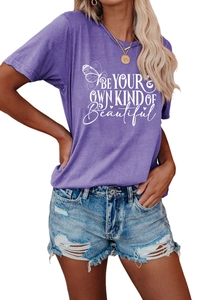Detailed view of the 'Be Your Own Kind Of Beautiful' slogan and butterfly print on a T-shirt