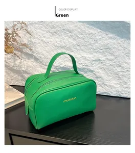 Detailed close-up of a vibrant green PU leather cosmetic bag with a lychee grain texture