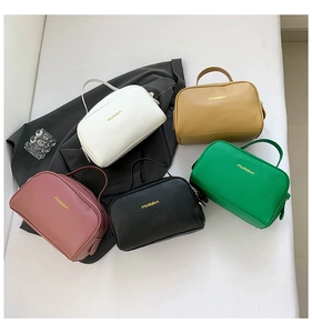 Detailed group shot of five portable PU leather toiletry bags in various trendy colors