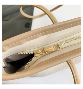 Detailed close-up of premium synthetic leather texture and golden metal zipper on tote bag