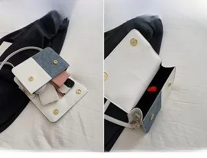 Detail showing the spacious main pocket of the color-block crossbody bag and its storage