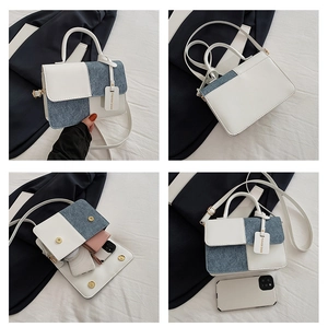 Detail of white leather and blue denim patchwork mini crossbody bag with magnetic closure