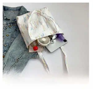 Macro shot of white tote bag interior with embroidery detail showing large storage space