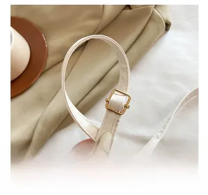 Détail de la bandoulière en cuir PU blanc avec boucle en métal doré réglable de qualité