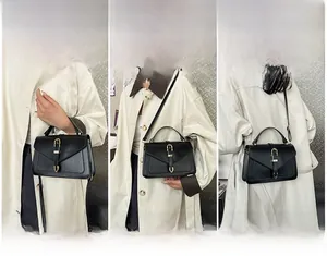 Detail of black envelope clutch showing hand-held, shoulder, and crossbody carry options