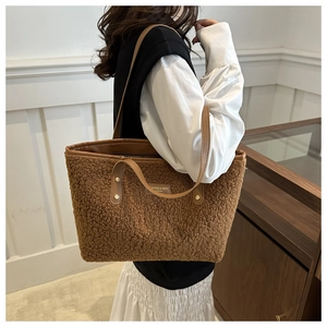 Detail of caramel faux fur tote bag showing plush texture and brown leather straps