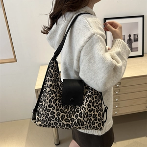 Classic leopard print tote bag with black leather flap shown in a daily lifestyle setting