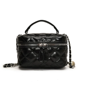 Chic black quilted crossbody bag with gold chain strap and top handle for women
