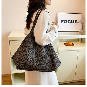 Detail shot of large leopard print canvas tote bag with sturdy stitching and wide shoulder straps