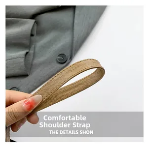 Detail of khaki leather shoulder strap with fine stitching and soft texture for baguette bag