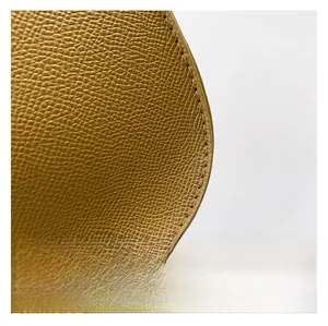 Macro detail of high-quality pebbled leather texture and neat stitching on shoulder bag