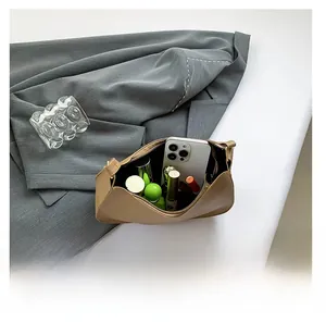 Interior view showing the large capacity of the light brown pebbled leather bag with essentials