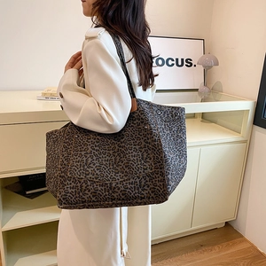 Fashionable leopard print canvas tote bag with outer pocket and rivet details