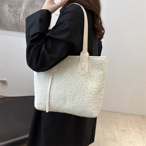 Chic white fuzzy faux shearling tote bag with leather handles for autumn and winter outfits