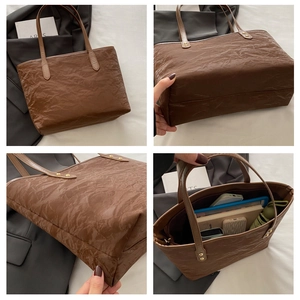Macro details of brown tote bag with wrinkled texture and large storage capacity