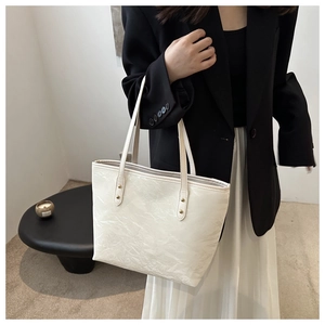 Chic white tote bag with marble texture and gold rivets for professional women commuting