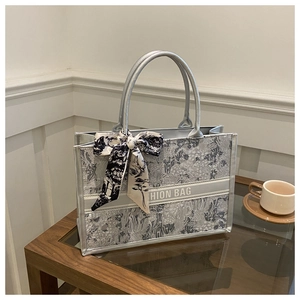 Detail of silver grey floral tote bag with silk scarf handle and Fashion Bag stripe