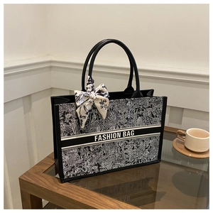 Close-up of the vintage botanical print tote bag with decorative silk scarf on handles