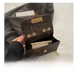 Detailed interior view of vintage brown chain bag showing phone and wallet storage