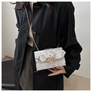 Detail view of white crossbody bag with letter print and heart-shaped metal lock