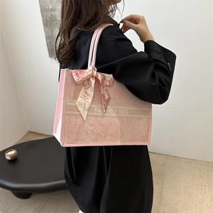Pink floral tote bag with bow ribbon and fashion bag text shown as shoulder bag