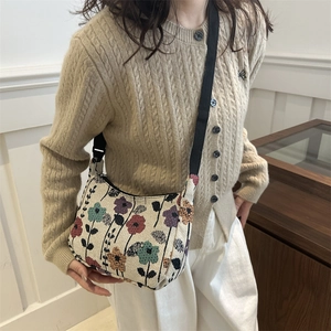 Retro crescent bag with colorful floral jacquard pattern and adjustable black strap