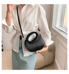 Chic black pleated crescent bag with circular handle and detachable crossbody strap