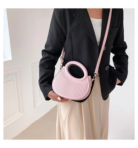 Detail of pink semi-circular handbag with vertical stripes and matching shoulder strap