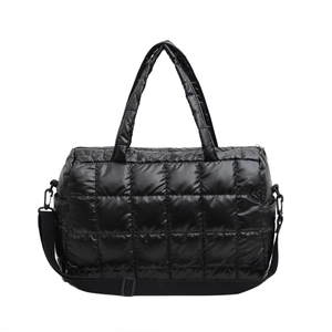 Glossy black quilted puffer crossbody bag with top handles and adjustable strap