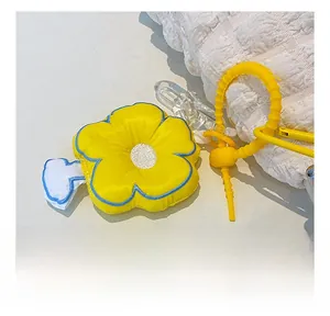 Detail of yellow sunflower fabric pendant with blue stitched edges and plastic link chain