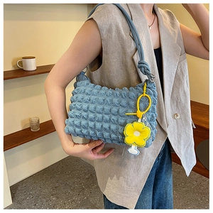 Blue bubble texture shoulder bag with yellow flower charm and knotted rope strap details