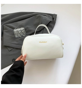 Close-up of white lychee pattern PU leather makeup bag with double zippers and gold logo